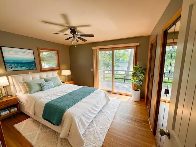 bedroom featuring light hardwood / wood-style floors, ceiling fan, and access to outside