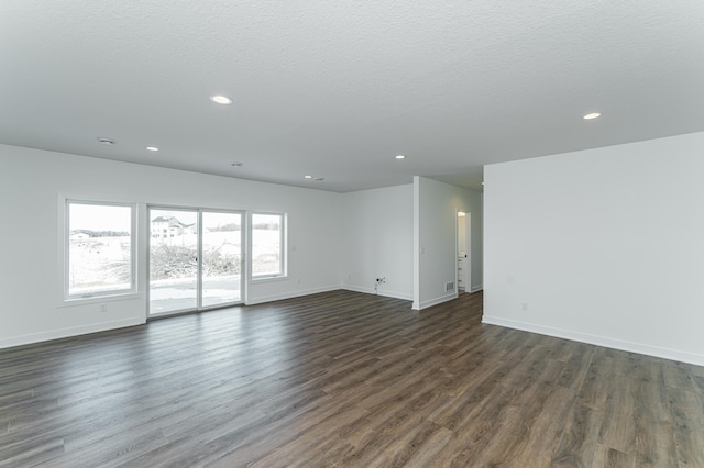 empty room with a textured ceiling and hardwood / wood-style floors