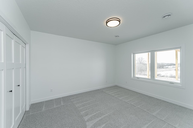 unfurnished bedroom featuring carpet and a closet