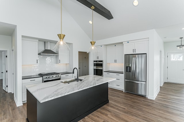 kitchen with appliances with stainless steel finishes, sink, dark wood-type flooring, and wall chimney range hood