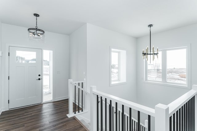 entrance foyer featuring dark wood-type flooring and a chandelier