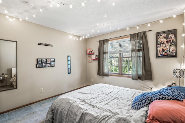 bedroom featuring carpet and a textured ceiling