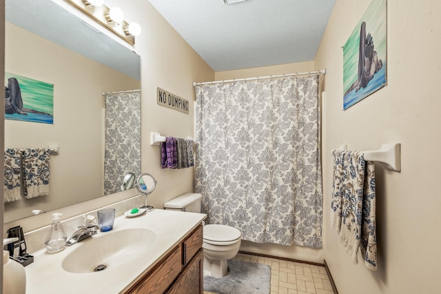 bathroom with tile patterned flooring, toilet, a textured ceiling, and vanity