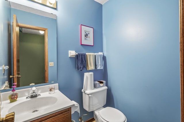 bathroom with toilet and vanity