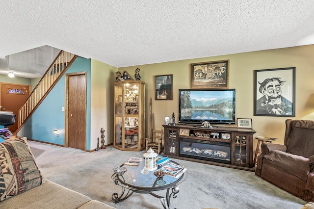 living room featuring carpet and a textured ceiling