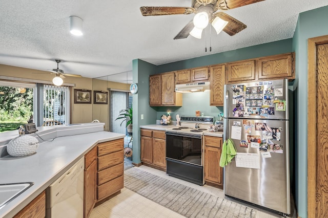 kitchen with ceiling fan, a textured ceiling, light tile patterned flooring, and white appliances