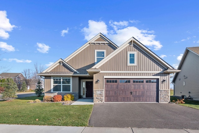 craftsman-style home featuring a front yard and a garage