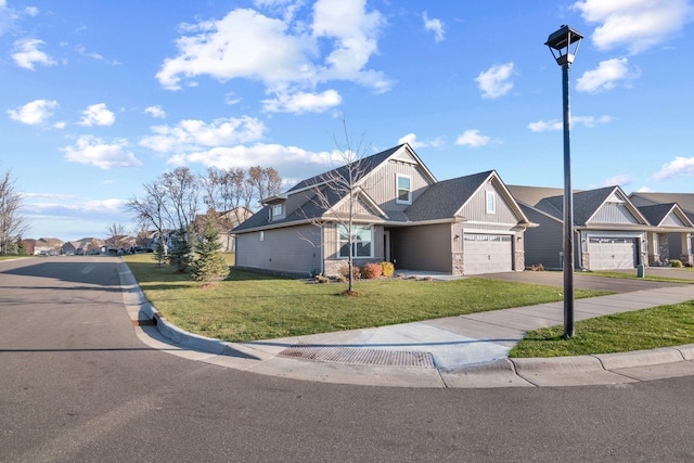 view of front of home with a front yard and a garage