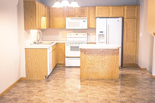 kitchen with white appliances, sink, light tile patterned flooring, and a center island