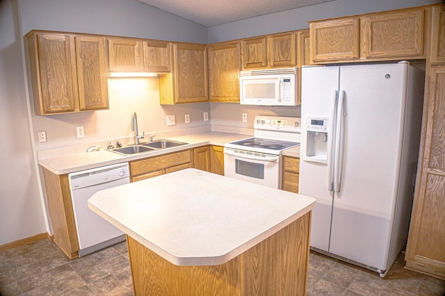 kitchen featuring sink, dark tile patterned floors, white appliances, and a center island