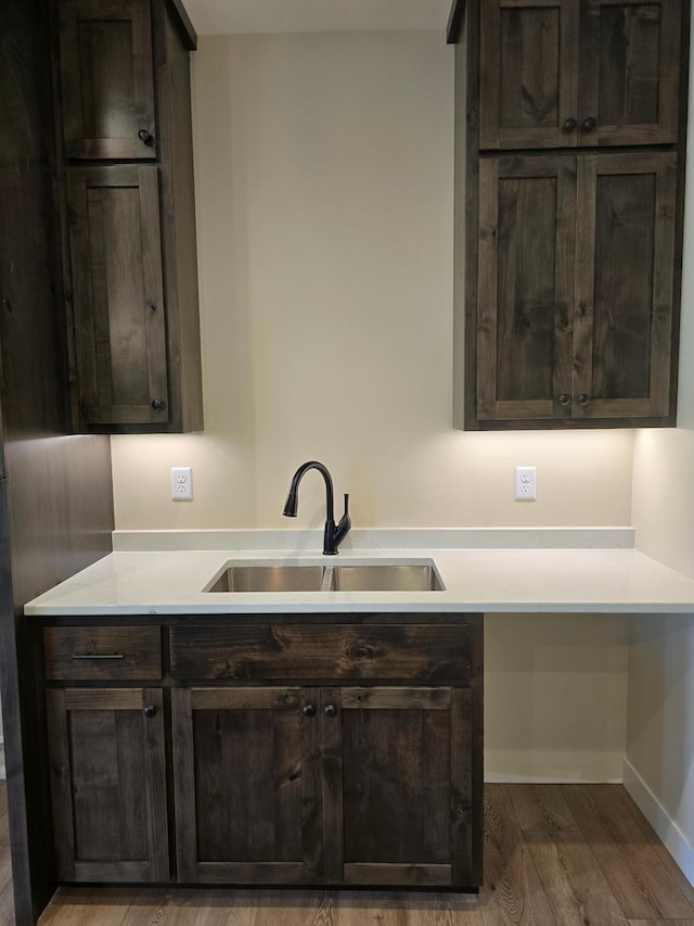 kitchen featuring sink, light hardwood / wood-style floors, and dark brown cabinetry