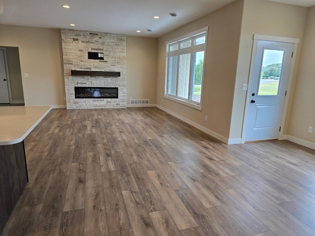 unfurnished living room with a fireplace and hardwood / wood-style floors