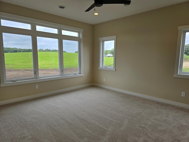 spare room featuring ceiling fan and carpet