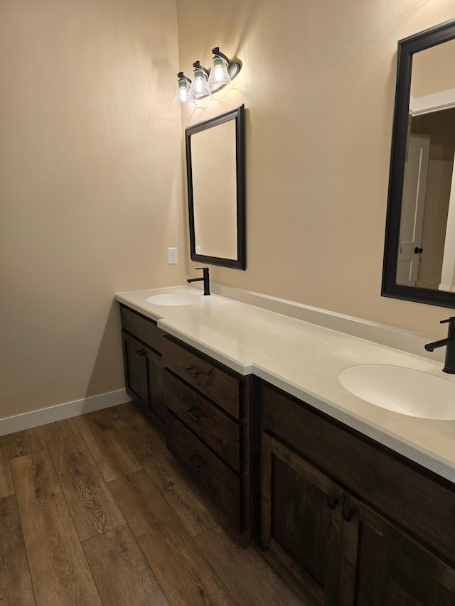 bathroom with hardwood / wood-style flooring and dual bowl vanity