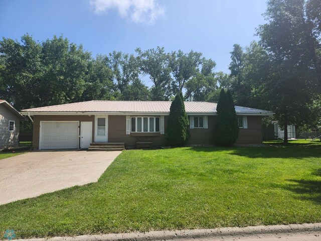 single story home with a garage and a front yard