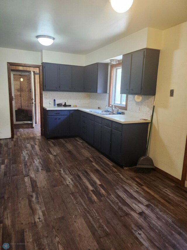 kitchen with sink, dark hardwood / wood-style floors, and tasteful backsplash