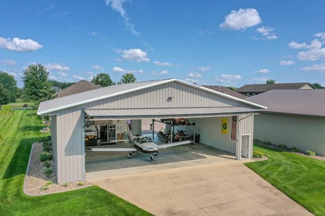 rear view of house with a yard, a garage, and metal roof