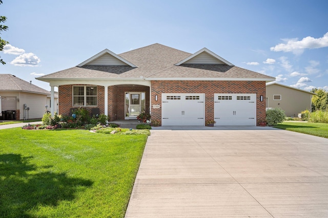 view of front of property with brick siding, an attached garage, a front yard, and a shingled roof