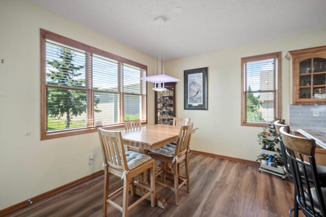 dining room featuring baseboards and wood finished floors