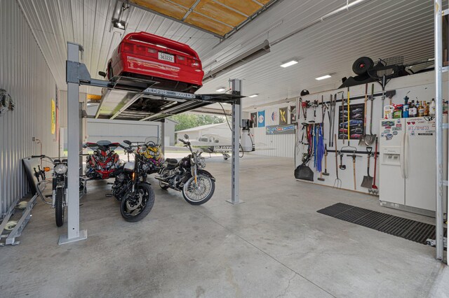 garage with white refrigerator with ice dispenser