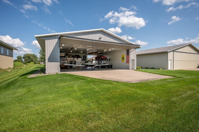 rear view of property with a yard, an outbuilding, and an outdoor structure