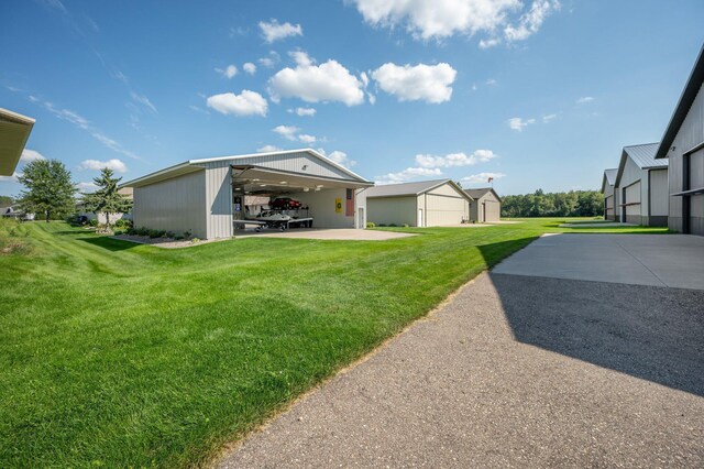 view of yard with a garage, an outbuilding, and an outdoor structure