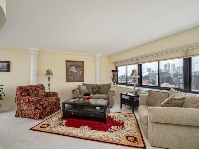 carpeted living room featuring ornate columns and crown molding