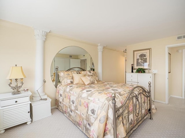 bedroom with baseboards, ornate columns, visible vents, and light colored carpet