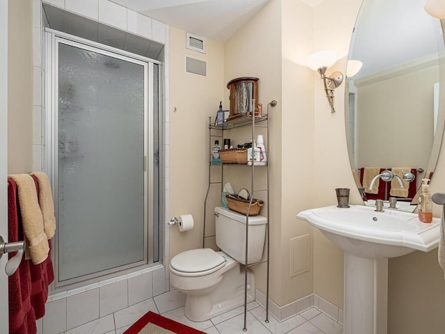 bathroom featuring a stall shower, baseboards, visible vents, toilet, and tile patterned floors