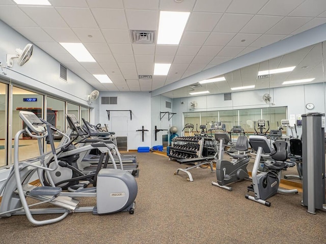 workout area featuring a paneled ceiling and visible vents