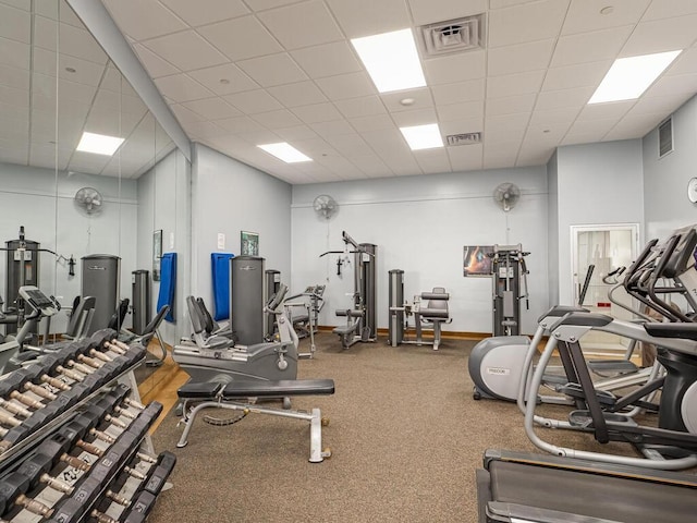 exercise room with a paneled ceiling and visible vents