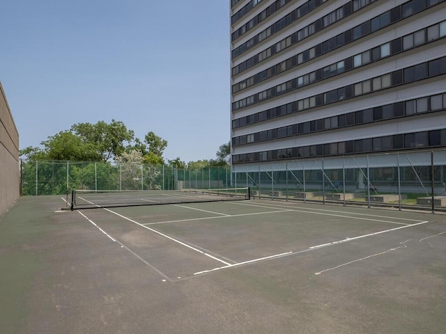 view of tennis court with fence