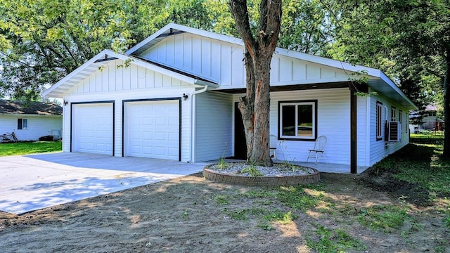 view of front of house with cooling unit and a garage