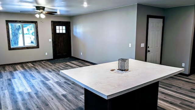 kitchen with ceiling fan and dark wood-type flooring