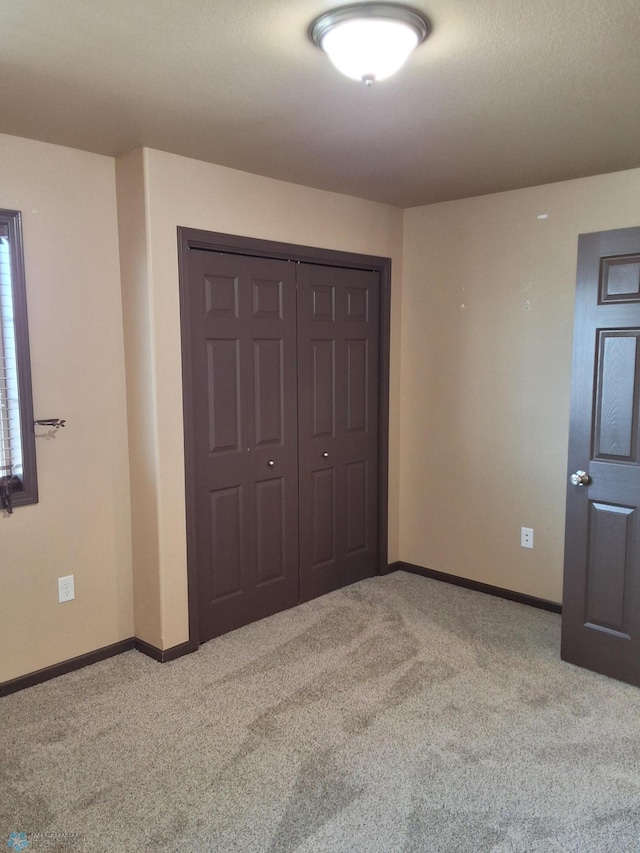 915 30th Ave W, West Fargo, ND 58078 - unfurnished bedroom featuring light colored carpet and a closet