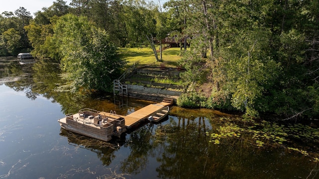 dock area featuring a water view and a lawn