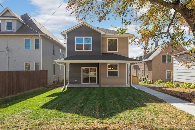 rear view of property with a patio area and a lawn