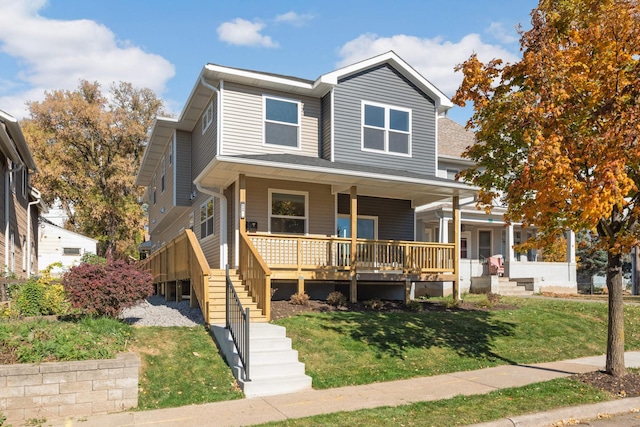 view of front of home with a front yard and covered porch