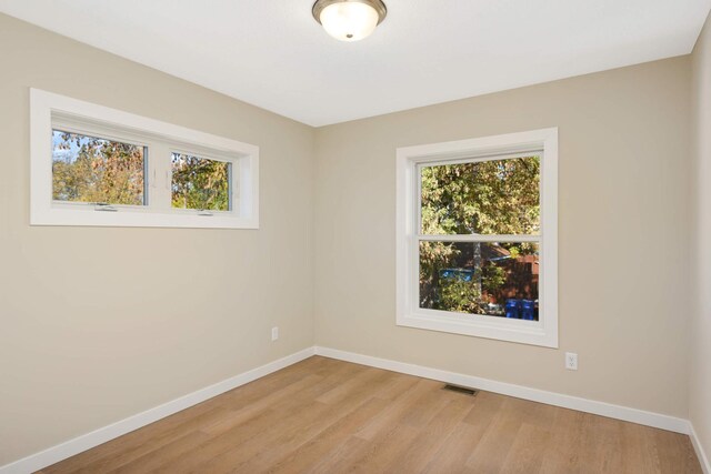 empty room with light hardwood / wood-style flooring