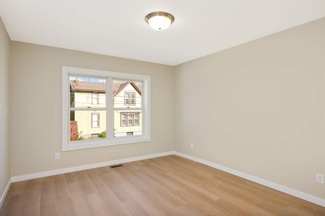 spare room featuring light hardwood / wood-style flooring