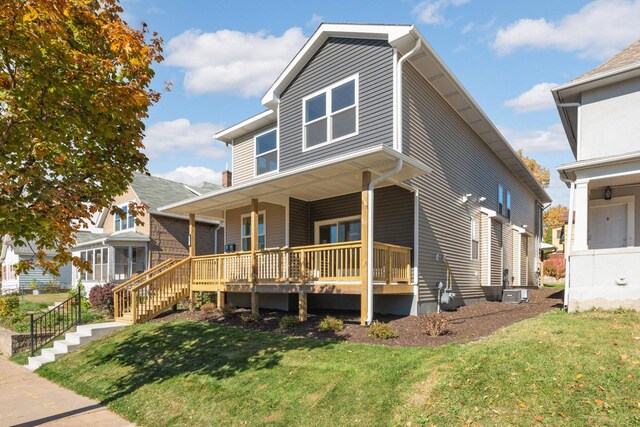 view of front of house featuring a front yard and covered porch