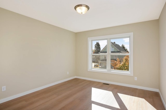 empty room with hardwood / wood-style floors