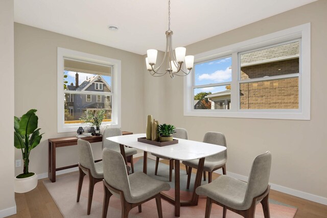 dining room featuring wood-type flooring and a chandelier