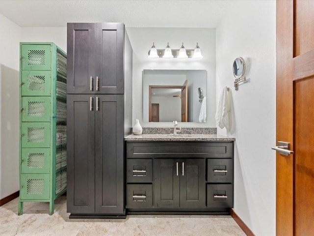 bathroom with baseboards and vanity