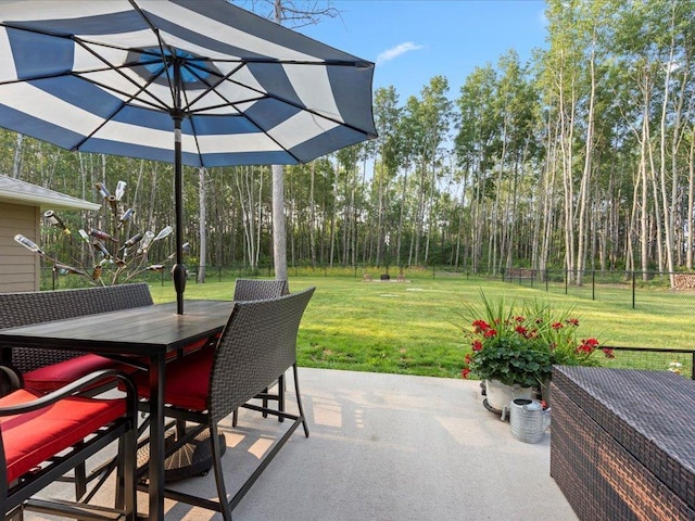 view of patio featuring fence and outdoor dining space