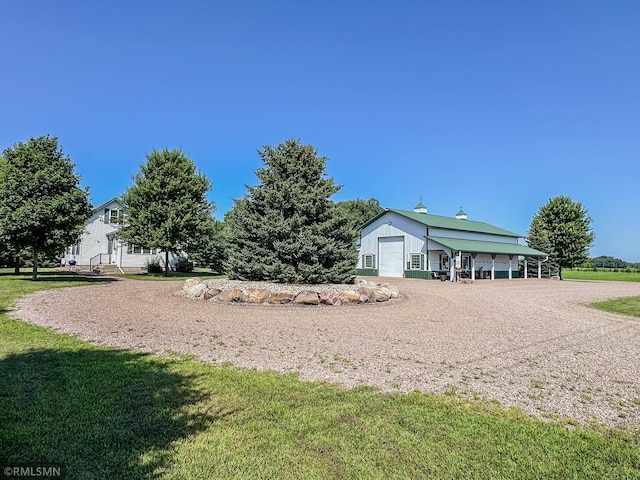 surrounding community featuring a lawn and an outbuilding