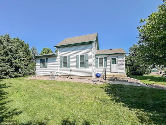 rear view of house with a yard