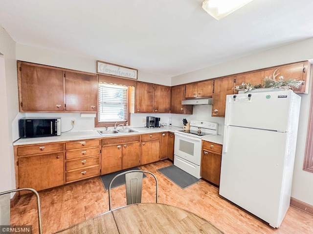 kitchen with sink, light hardwood / wood-style floors, and white appliances