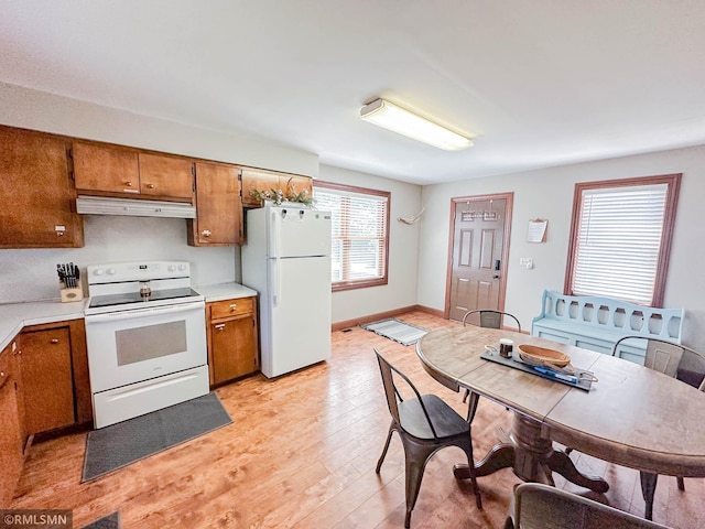 kitchen with white appliances and light wood-type flooring