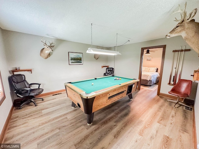 recreation room featuring billiards, a textured ceiling, and light hardwood / wood-style flooring